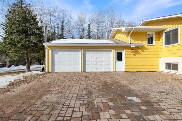 garage featuring decorative driveway