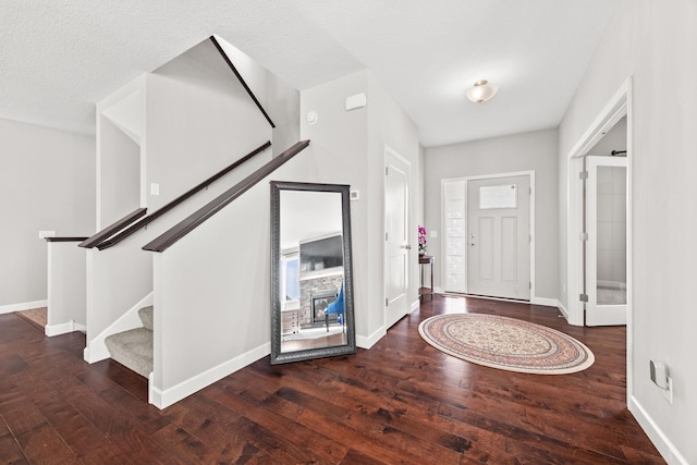 entryway with baseboards, stairs, and hardwood / wood-style flooring