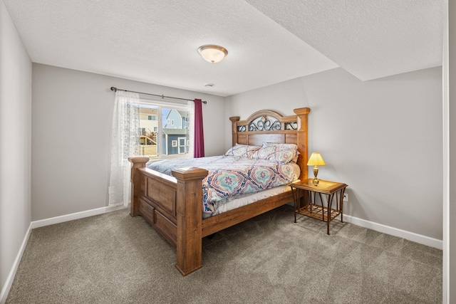 carpeted bedroom with a textured ceiling and baseboards