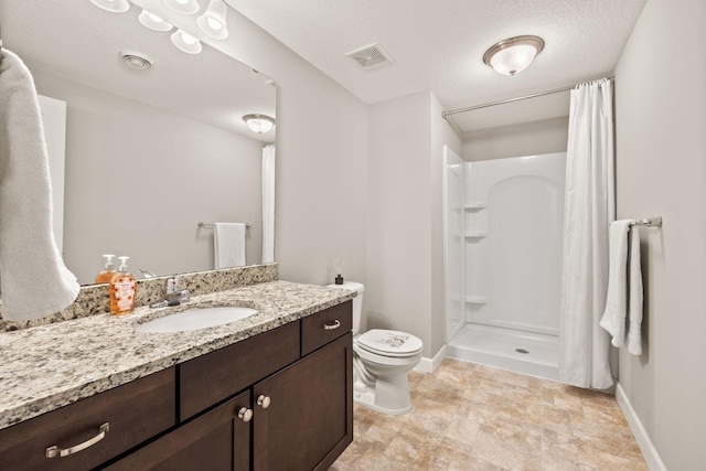 bathroom featuring visible vents, toilet, vanity, a shower with curtain, and a textured ceiling