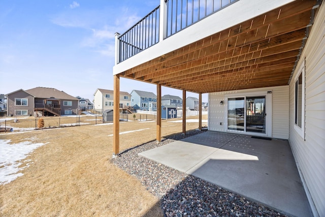 view of patio with a residential view and fence