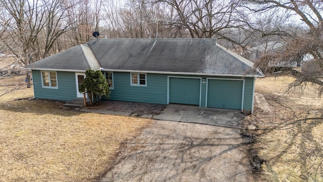 view of front of property featuring driveway and a shingled roof