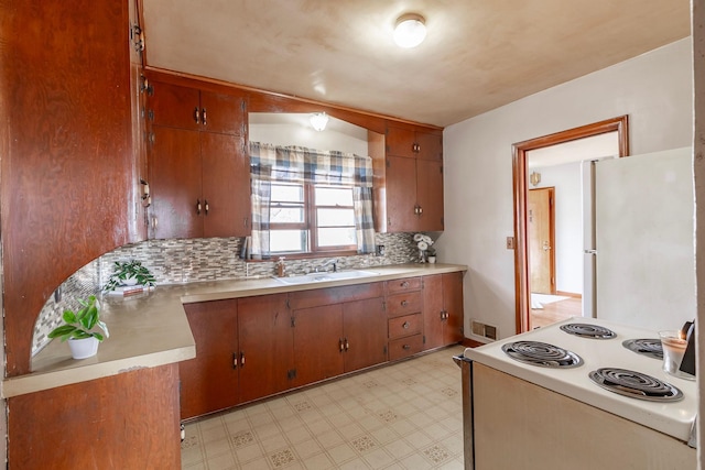 kitchen with white appliances, light floors, visible vents, and light countertops