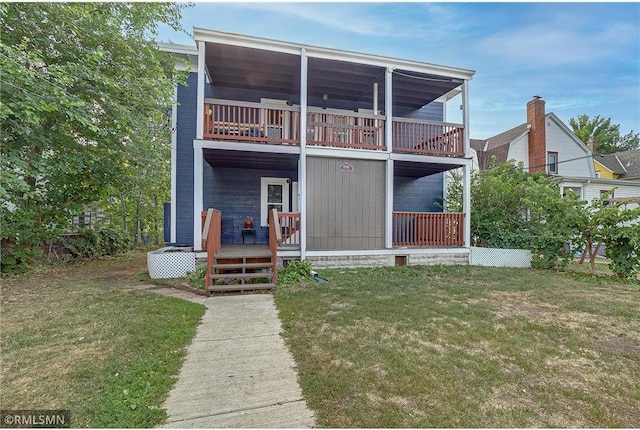 rear view of house with a yard