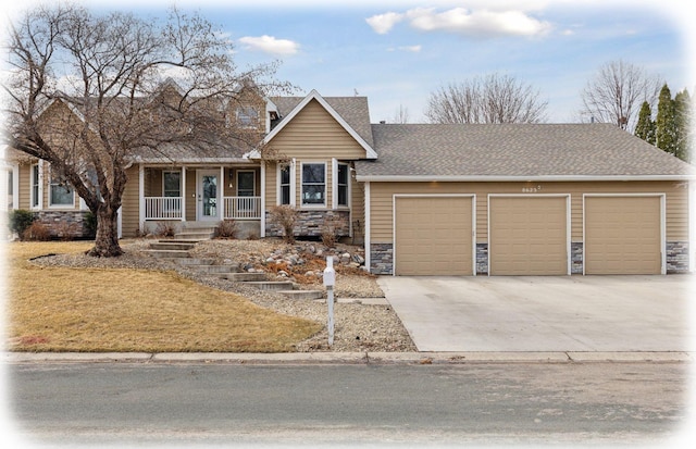 view of front of house featuring stone siding, covered porch, concrete driveway, a shingled roof, and a garage