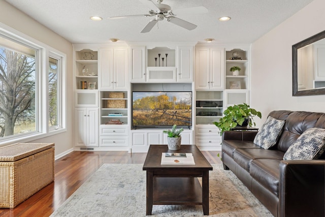 living room with recessed lighting, a textured ceiling, wood finished floors, and a ceiling fan