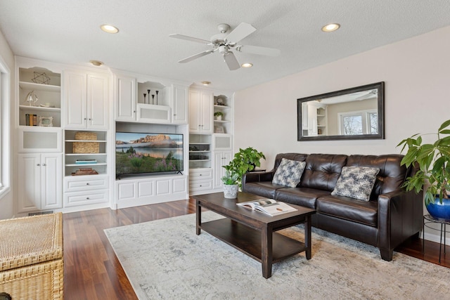 living room with visible vents, a ceiling fan, a textured ceiling, wood finished floors, and recessed lighting