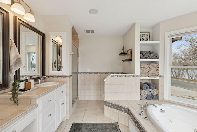 bathroom featuring visible vents, a stall shower, tile walls, tile patterned flooring, and a whirlpool tub