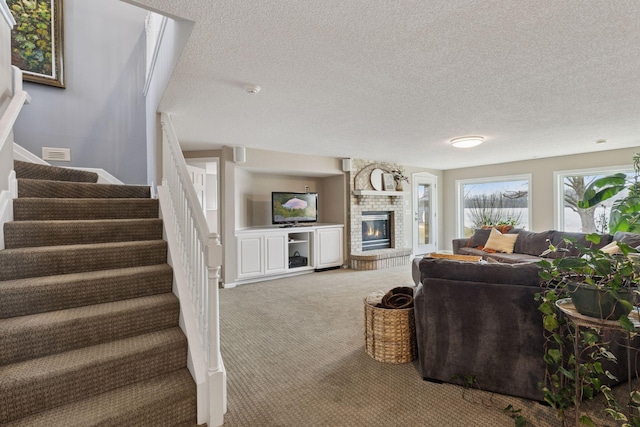 living room featuring stairway, carpet flooring, visible vents, and a textured ceiling