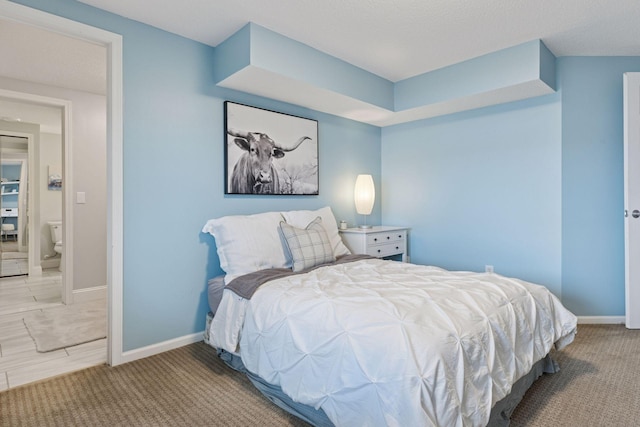 carpeted bedroom with baseboards