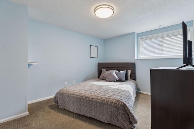 carpeted bedroom with baseboards and a textured ceiling