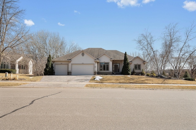 view of front of home featuring concrete driveway, a garage, and stucco siding