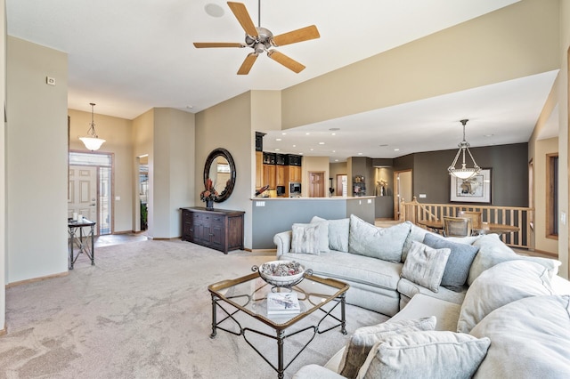 living room with baseboards, ceiling fan, carpet flooring, and vaulted ceiling