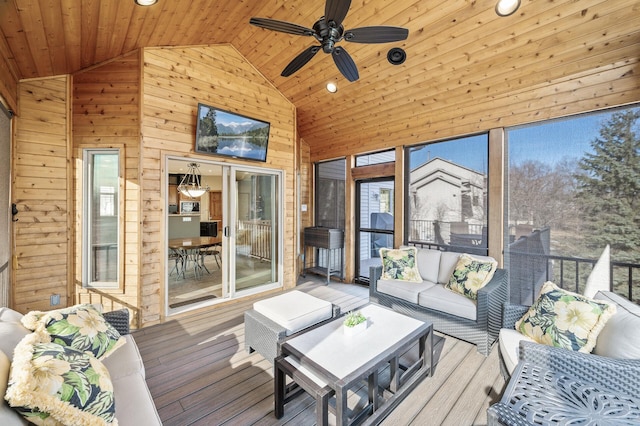 sunroom with ceiling fan, wood ceiling, and lofted ceiling