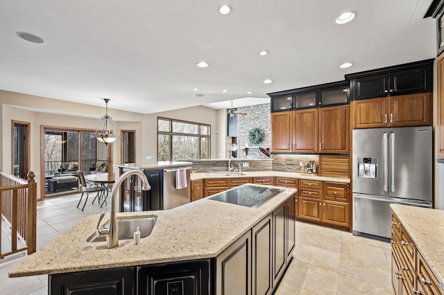 kitchen featuring tasteful backsplash, a kitchen island, stainless steel appliances, and a sink