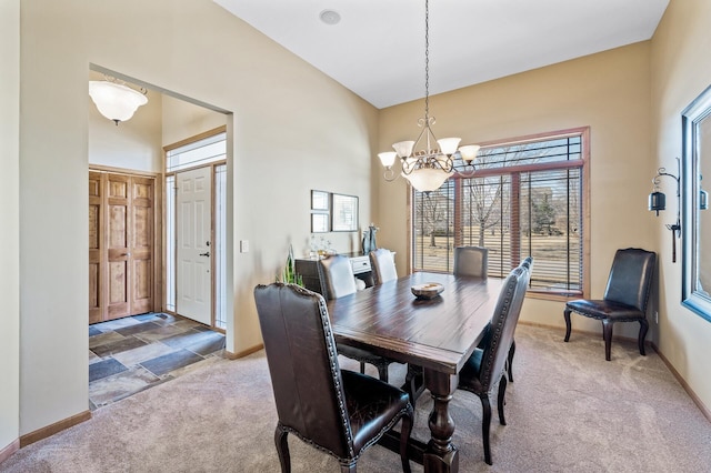 dining room with a notable chandelier, carpet, baseboards, and a towering ceiling