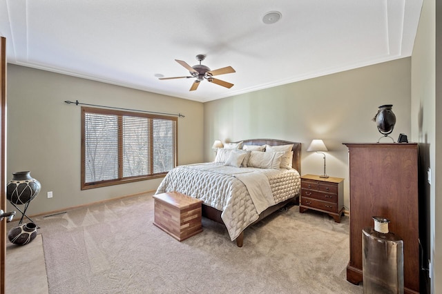 bedroom with ceiling fan, light colored carpet, visible vents, and ornamental molding