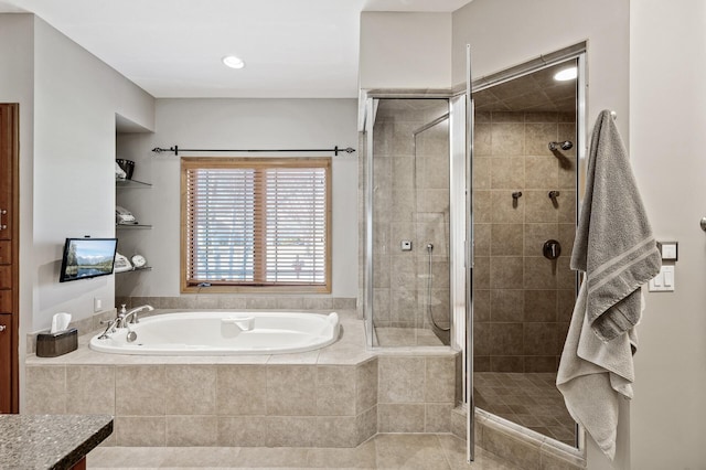 full bath featuring a shower stall and a garden tub