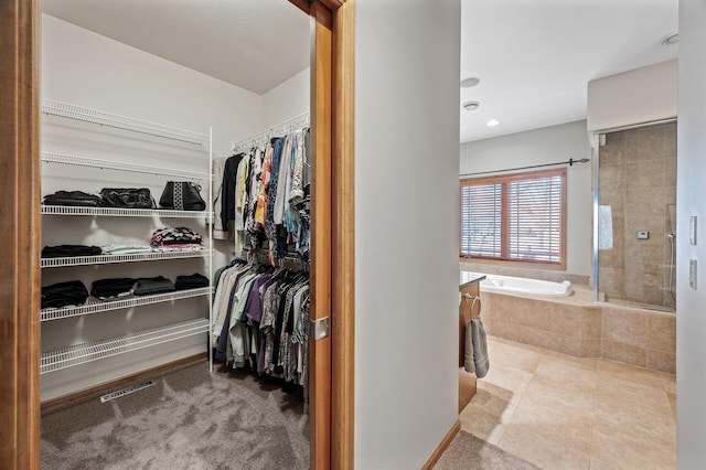 walk in closet with tile patterned floors