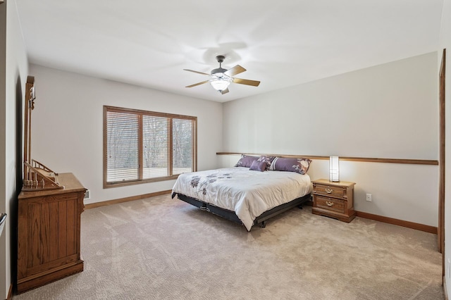 bedroom with light carpet, a ceiling fan, and baseboards