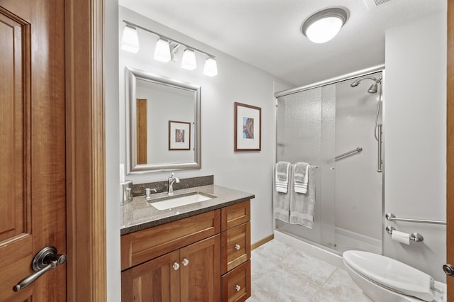 full bath with baseboards, vanity, toilet, and a shower stall