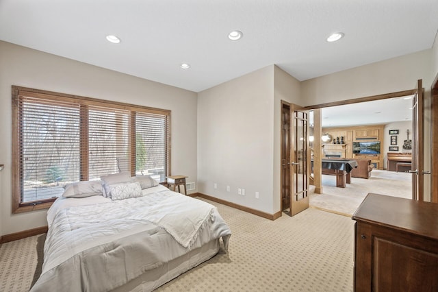 bedroom with recessed lighting, light colored carpet, and baseboards