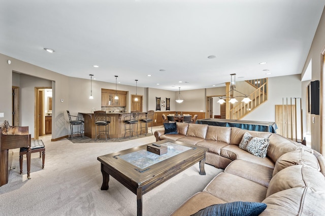 living area with recessed lighting, stairway, and light colored carpet