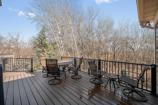 wooden deck featuring outdoor dining area