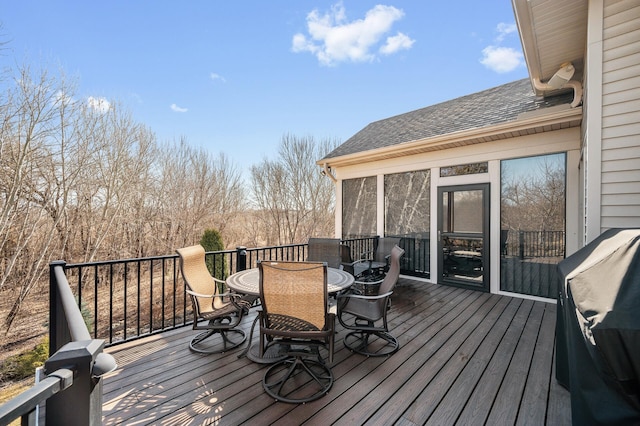 wooden deck featuring outdoor dining space and area for grilling