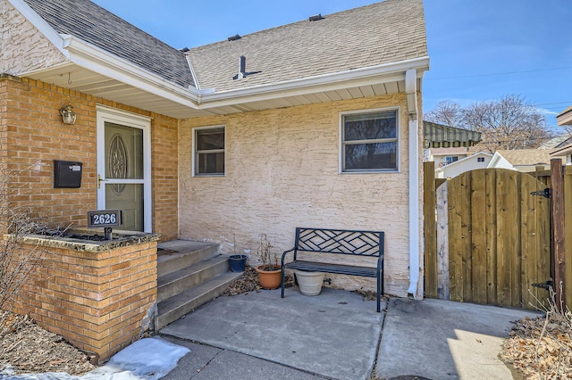 view of patio with fence and a gate