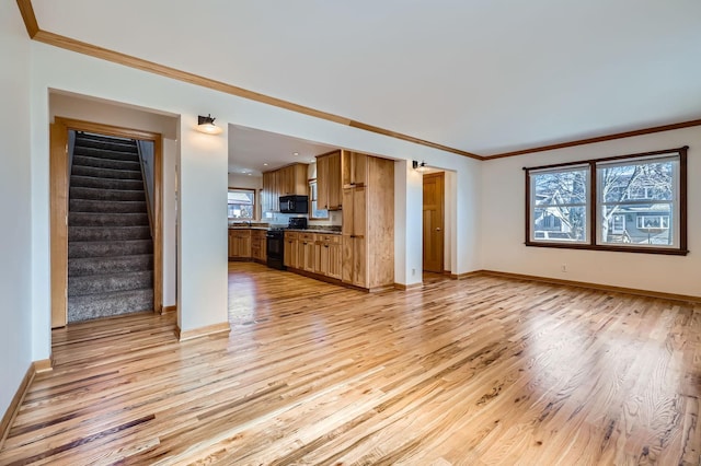 unfurnished living room featuring light wood finished floors, stairway, baseboards, and ornamental molding