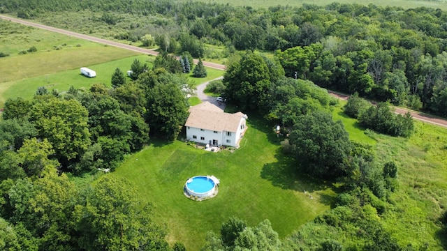 birds eye view of property with a rural view and a wooded view