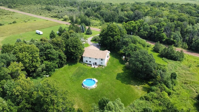 birds eye view of property featuring a view of trees and a rural view