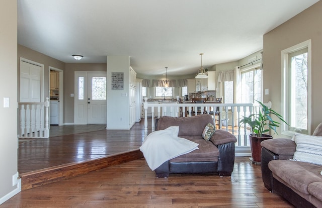 living area featuring hardwood / wood-style flooring and baseboards