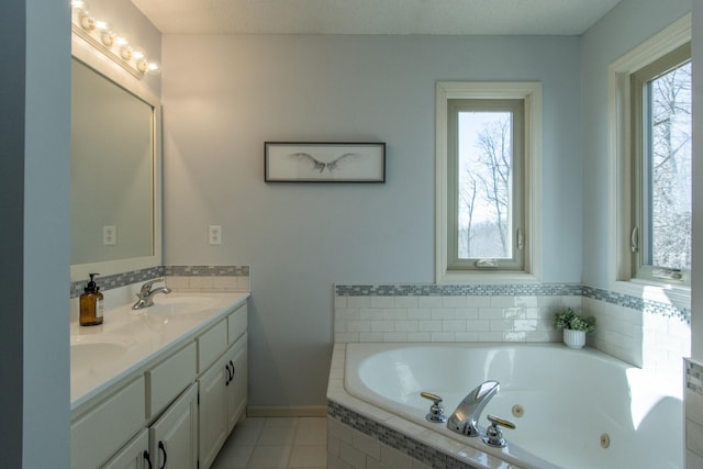 bathroom featuring a sink, a jetted tub, double vanity, and tile patterned floors
