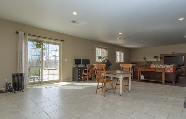 dining area with radiator heating unit, light tile patterned flooring, and recessed lighting