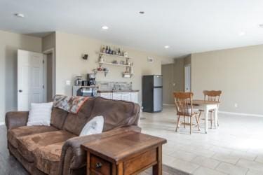 living room featuring recessed lighting and baseboards