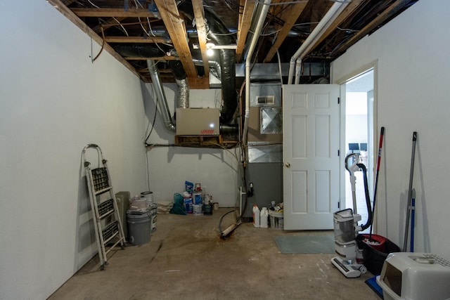 unfinished basement featuring heating unit