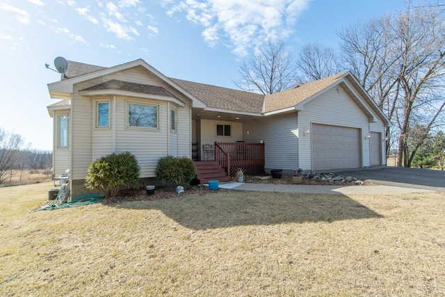 single story home with driveway, a front yard, roof with shingles, and an attached garage