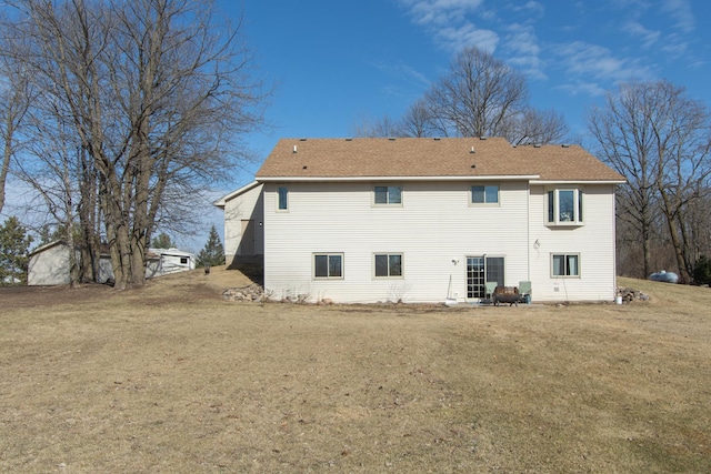 rear view of property with a lawn