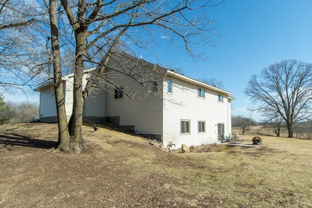 view of side of property with a yard