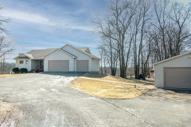 view of front facade with aphalt driveway and a garage