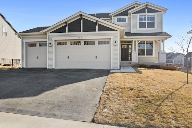 view of front facade with aphalt driveway and a garage