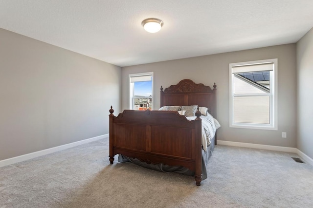 bedroom featuring visible vents, carpet, and baseboards