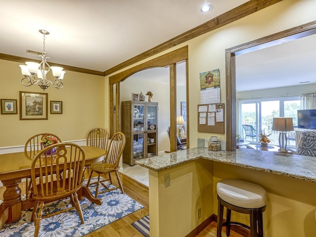 8621 Basswood Rd Unit 33, Eden Prairie, MN 55344 - dining room featuring visible vents, crown molding, light wood-style floors, and a chandelier