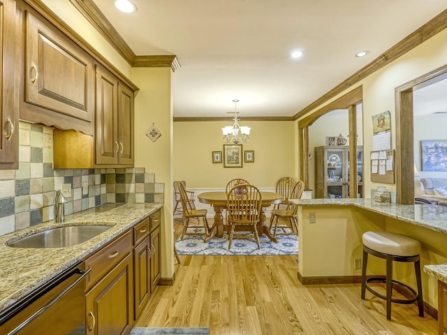 8621 Basswood Rd Unit 33, Eden Prairie, MN 55344 - kitchen with crown molding, a sink, light wood finished floors, dishwashing machine, and brown cabinetry