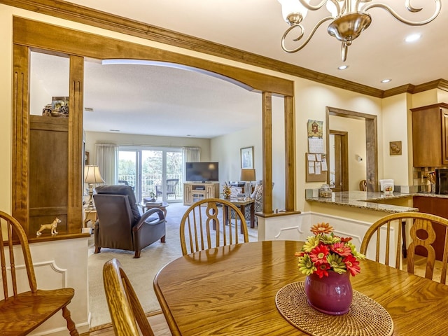 8621 Basswood Rd Unit 33, Eden Prairie, MN 55344 - dining room featuring light colored carpet, recessed lighting, ornamental molding, a chandelier, and arched walkways
