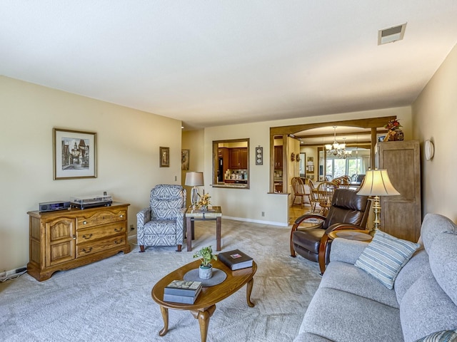 8621 Basswood Rd Unit 33, Eden Prairie, MN 55344 - living room featuring baseboards, visible vents, an inviting chandelier, and light colored carpet