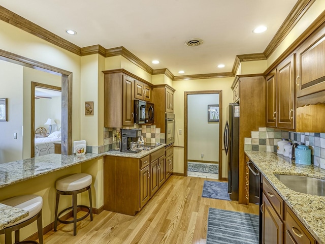 8621 Basswood Rd Unit 33, Eden Prairie, MN 55344 - kitchen with light wood-style flooring, visible vents, brown cabinetry, and appliances with stainless steel finishes