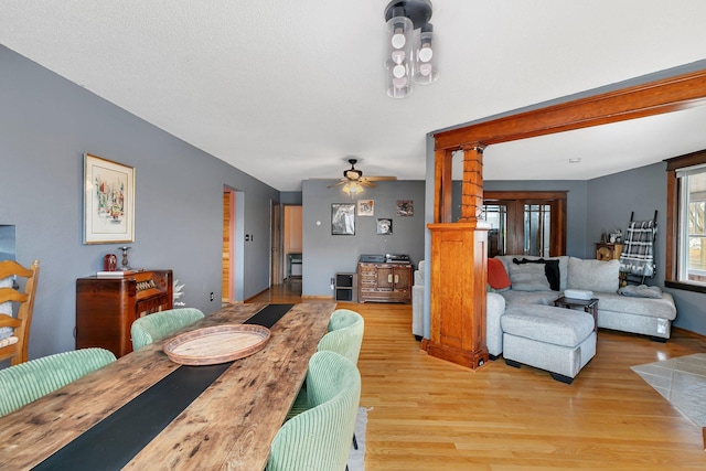 dining space with light wood-style floors and ceiling fan